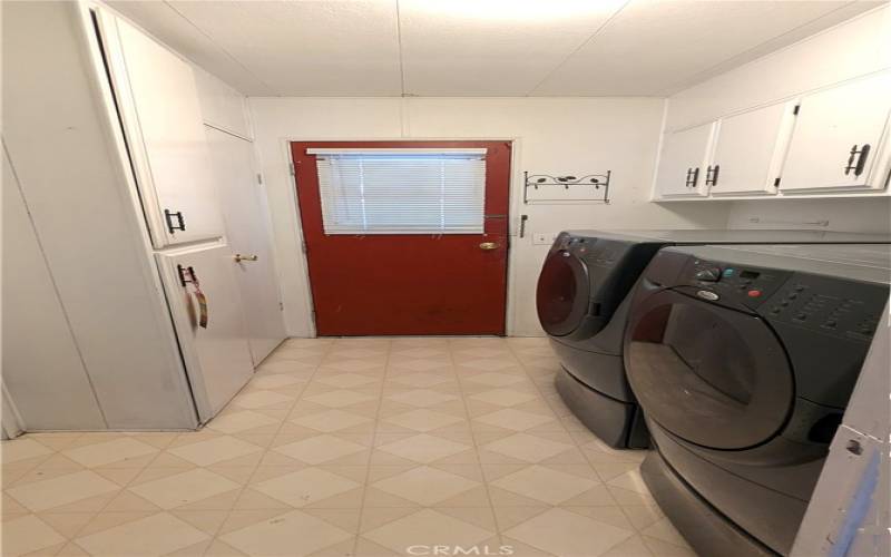 Separate Laundry Room has abundant storage and direct access to/from the Carport