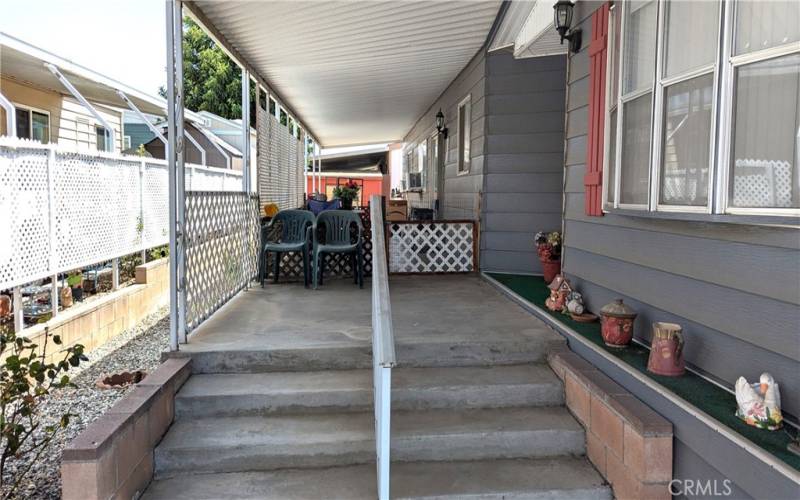 Covered front porch has additional covered BBQ and sitting area at back