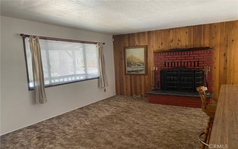 View of living room front window and fireplace