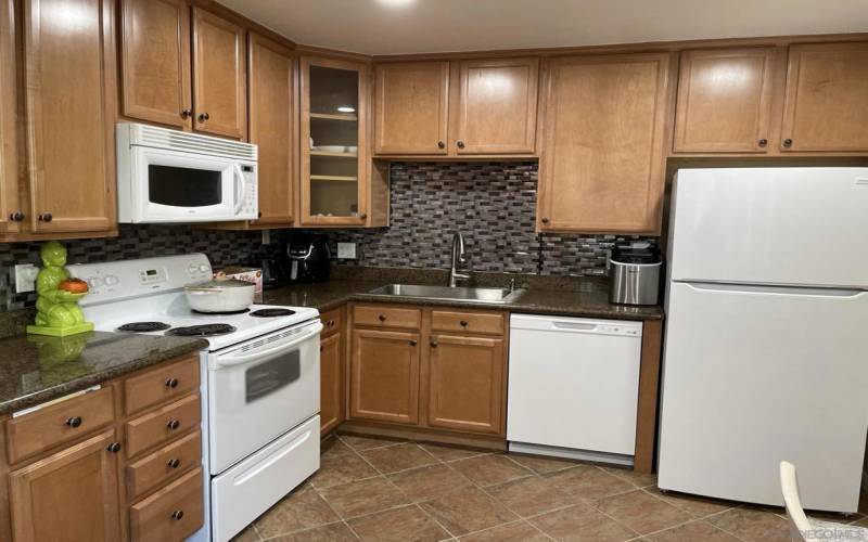 Kitchen with lots of cabinets and granite countertops