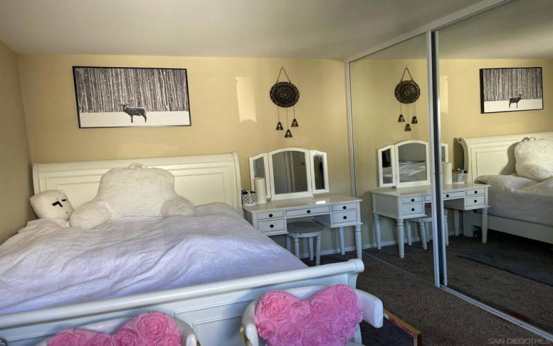 Primary bedroom with mirrored closet