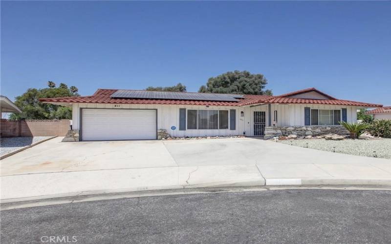 Extra wide driveway. Paid off solar panels on metal roof.