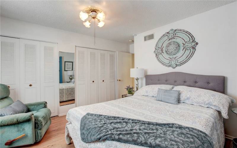 Secondary guest room has wood flooring & 2 closets.