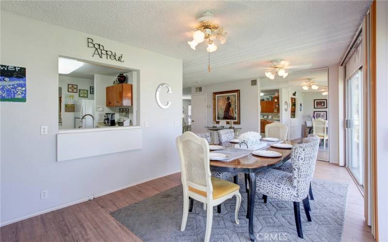 Mirrored doors to storage closet at end of dining table.