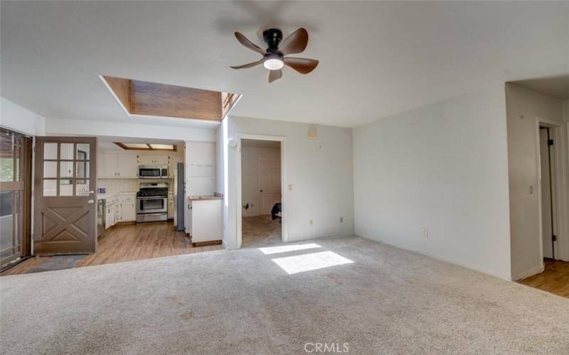 Livingroom toward kitchen with skylight