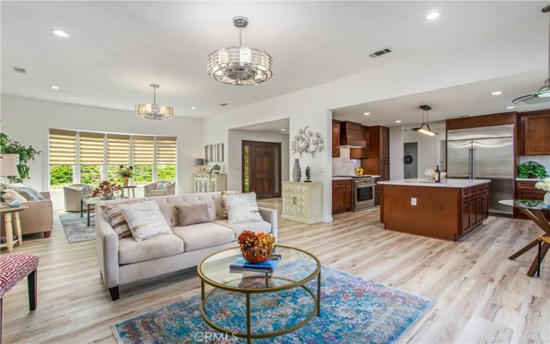 View toward front entry door.   Huge multipurpose great room open to kitchen.