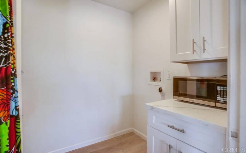 Space for a stackable washer and dryer right off kitchen