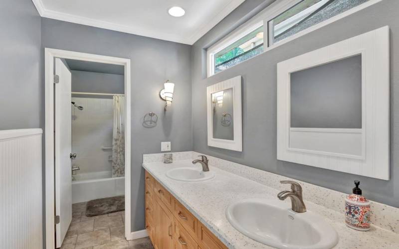 Main Level Bathroom with Dual Vanity Sinks and plenty of cabinets for storage