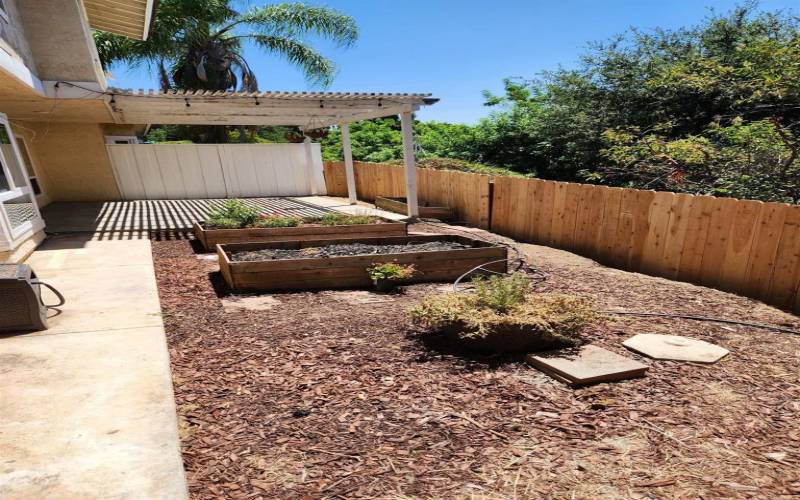 Backyard view with plenty of room for your own vegetable, herb, and/or flower garden