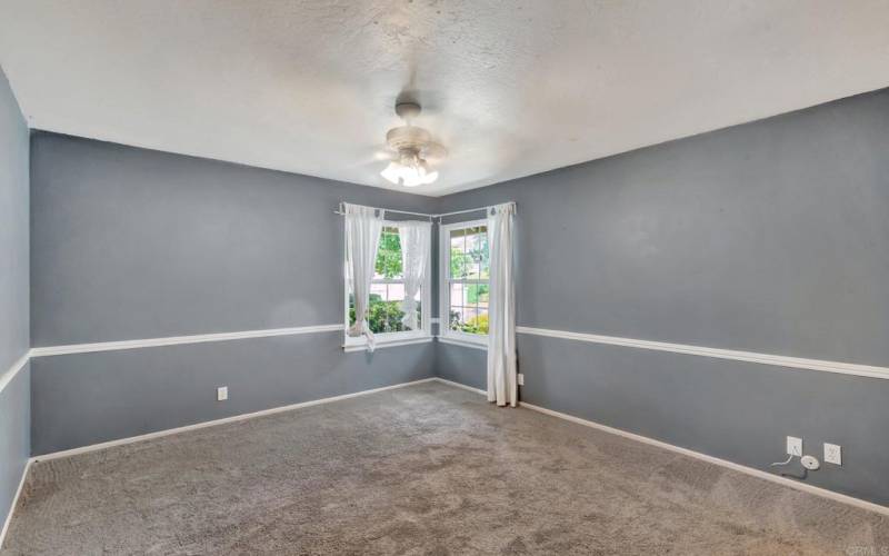 Main level bedroom with lots of natural light coming through the windows