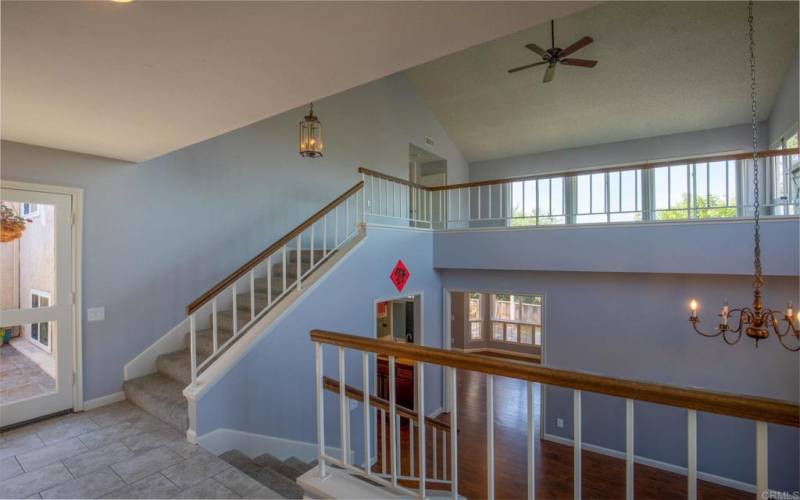 Stairs for a short walk to the upper level w/Vaulted ceilings and lots of windows in the Family Room