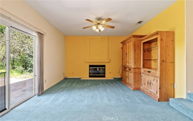 This cozy family room with fireplace and entertainment center, that stays, is sure to be the heart of the home. With a sliding door to the backyard, it is the perfect space for all to gather.