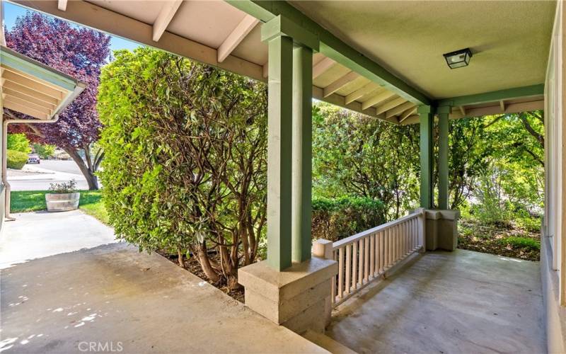 As you walk up to the front door, there is a quaint step-down, covered porch.