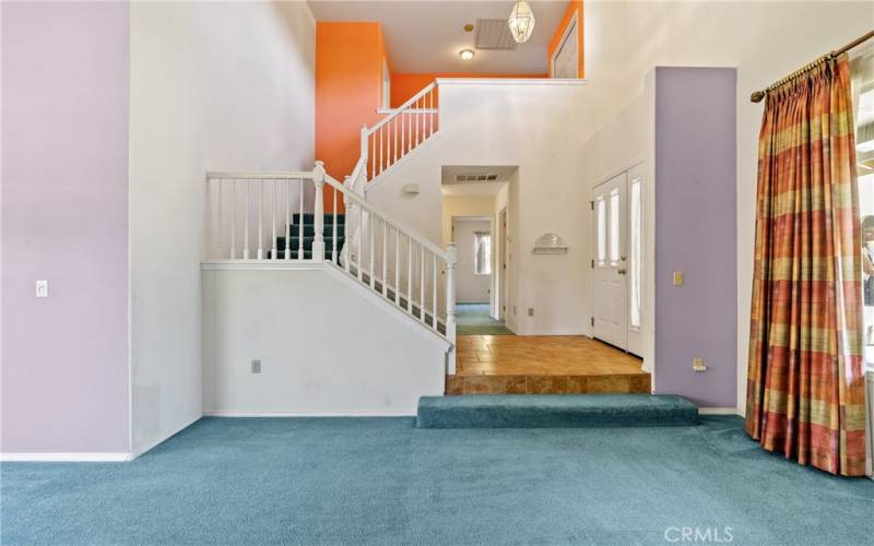 This formal entry is tiled with a magnificent pendant light. The approximately 17’ ceiling and grand stairway is a great place to greet your guests.