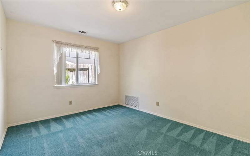 This flexible room is set up as an office with a 4th bedroom possibility. On the main level, this room is carpeted with a ceiling fan.