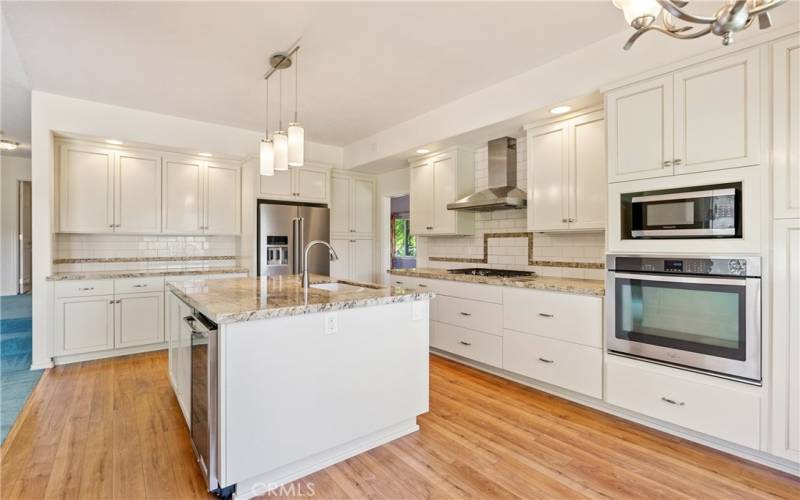 The fabulous kitchen has enjoyed a terrific remodel since the home was built. It has quality cabinetry with soft drawer pulls and pantry pull-out drawers that are every home cook’s dream. The fantastic granite counters are luxurious.