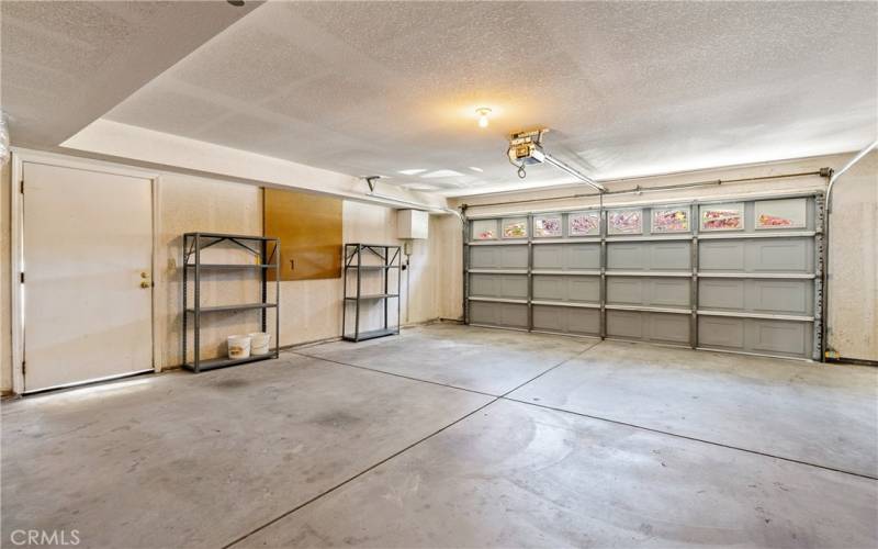 The large 2-car garage also includes shelving. Though not connected, there is a water softener available.