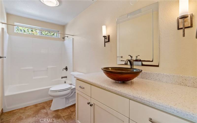 This bath enjoys the same quality and style cabinetry as the kitchen. With beautiful accents, it is centrally located on the first floor, it also has hard surface counters with a tub/shower combination.