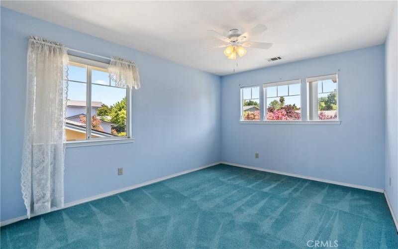 Bedroom 2 is carpeted with a ceiling fan.