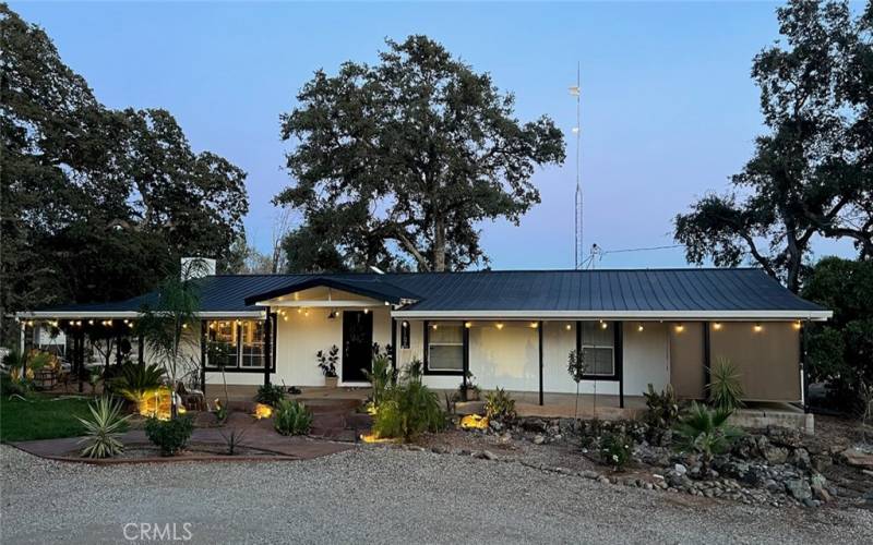 Long, covered front porch enjoys the peaceful sounds of a water feature and peaceful panoramic views.