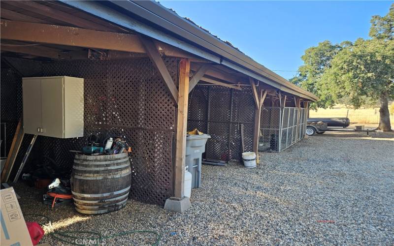 Front of the equipment shed has a dog run and carport spaces