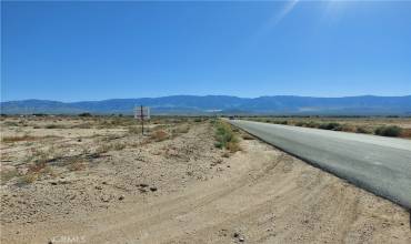 view to the south with paved road access on west side of lot