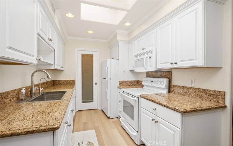 Galley style kitchen remodeled cabinets, granite counters, pantry and large skylight