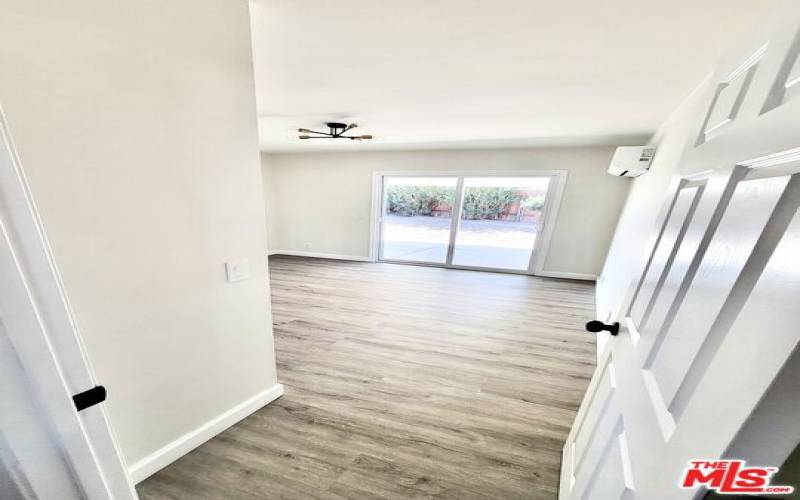 Bedroom #1 with large patio door that leads to the backyard