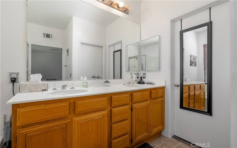 Master bathroom with double sink vanity and walk in closet.