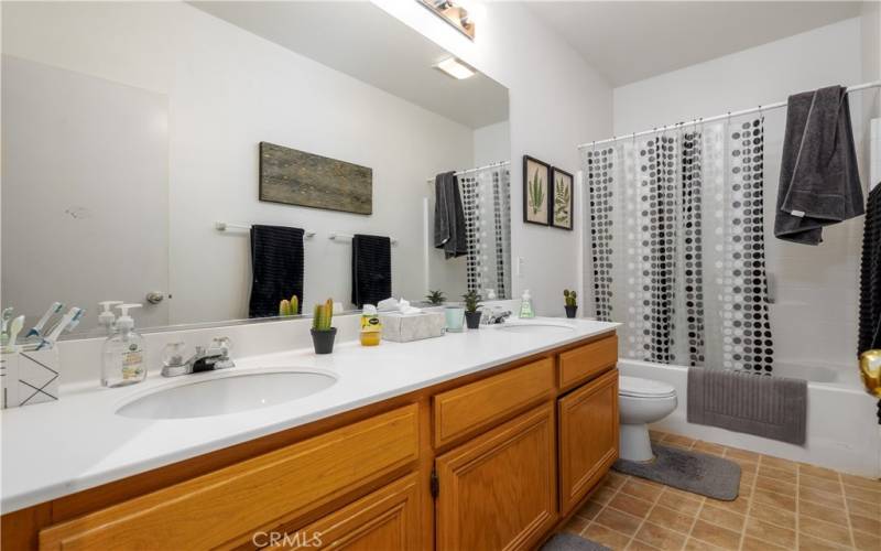 Secondary bathroom with double sink vanity.