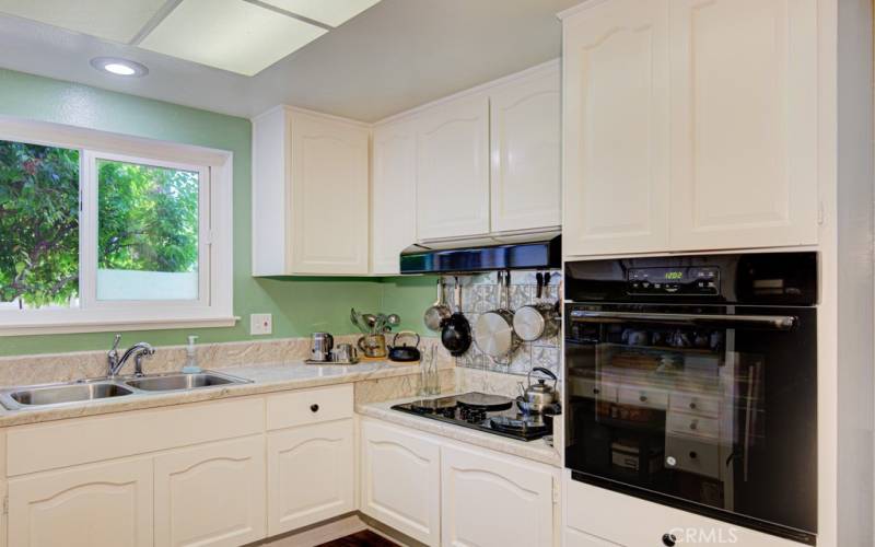 Nicely appointed kitchen has a built in oven, cooktop and a refrigerator - all owned an maintained by the HOA :-)