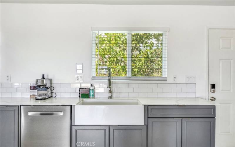 Large Country kitchen sink and stainless-steel dishwasher.