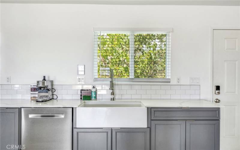 Large Country kitchen sink and stainless-steel dishwasher.