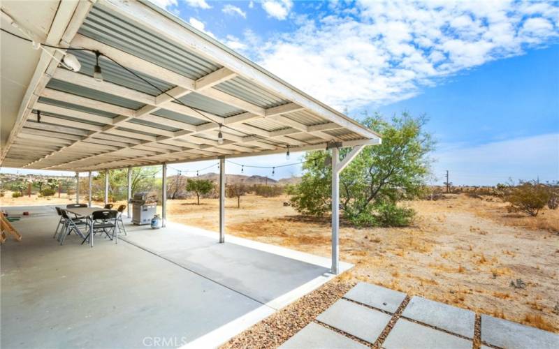 Back patio including corrugated galvanized steel roof.