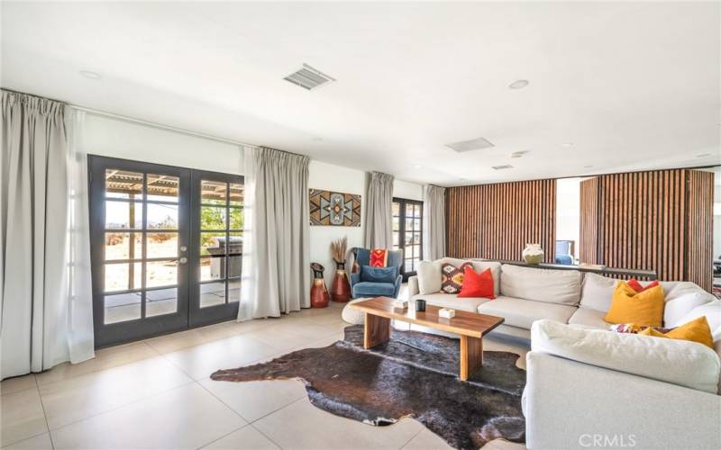 Open floor plan living room area including dual pane French doors.