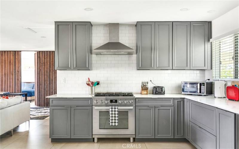 Open floor plan kitchen including subway tile backsplash.