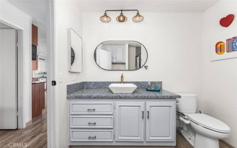 Secondary remodeled hallway bathroom with quarts countertop and Bidet Toilet.