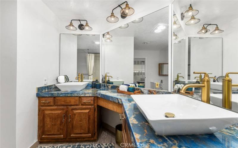 The master bathroom features Vessel sinks with nicely appointed porcelain countertops.