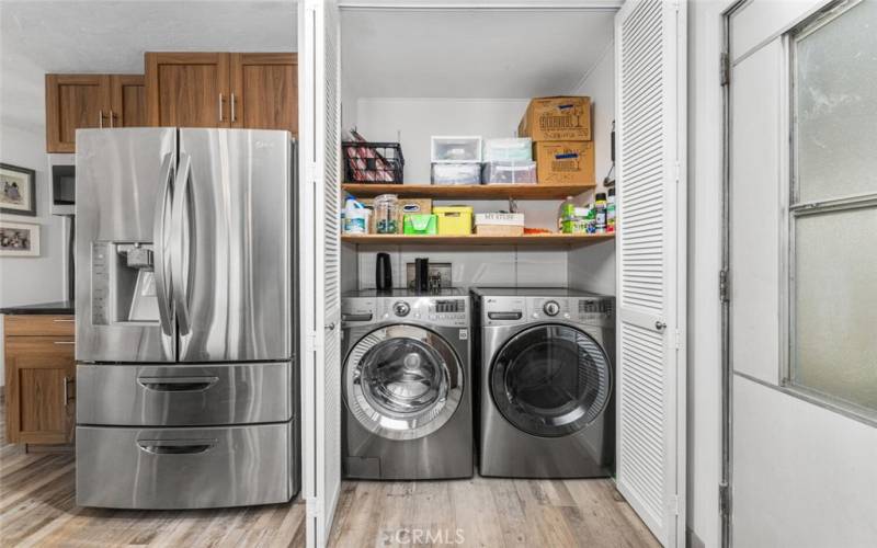 Inside laundry area with louvered doors to conceal appliances when not in use.