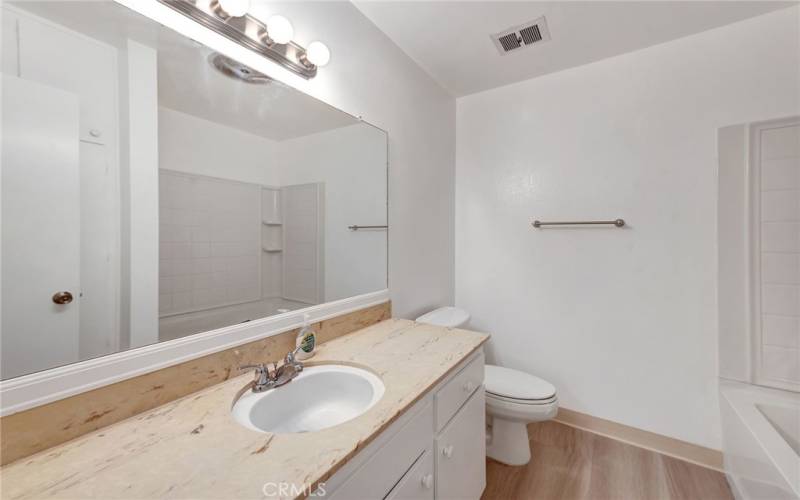 The bathroom features a long countertop