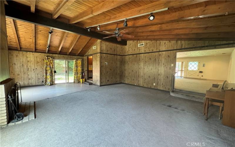 LARGE OPEN BEAM FAMILY ROOM WITH FIREPLACE AND ACCESS TO THE LARGE LAUNDRY AREA AND LIVING ROOM