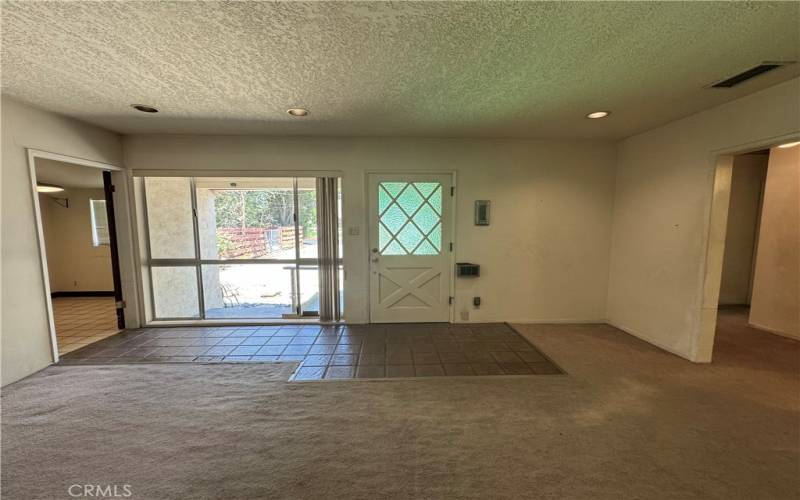 LARGE ENTRY AND LIVING ROOM WITH ACCESS TO THE LEFT WITH THE BREAKFAST AREA AND TO THE RIGHT ARE THE BEDROOMS