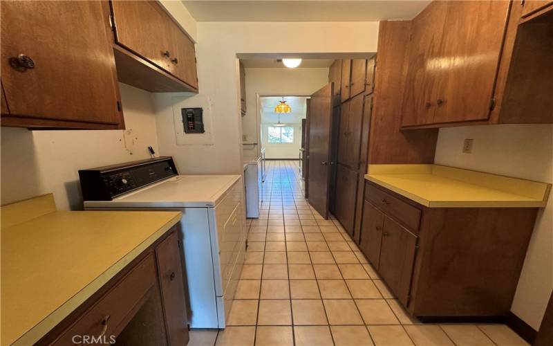 THIS IS THE LARGE LAUNDRY ROOM AREA WHERE YOU CAN POSSIBLY PUT A BATHROOM, KITCHENETTE SO MANY CABINETS