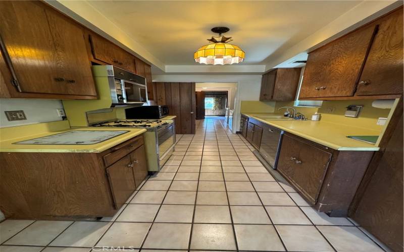 GALLEY KITCHEN TILED FLOORS AND PLENTY OF CABINET AND COUNTER SPACE