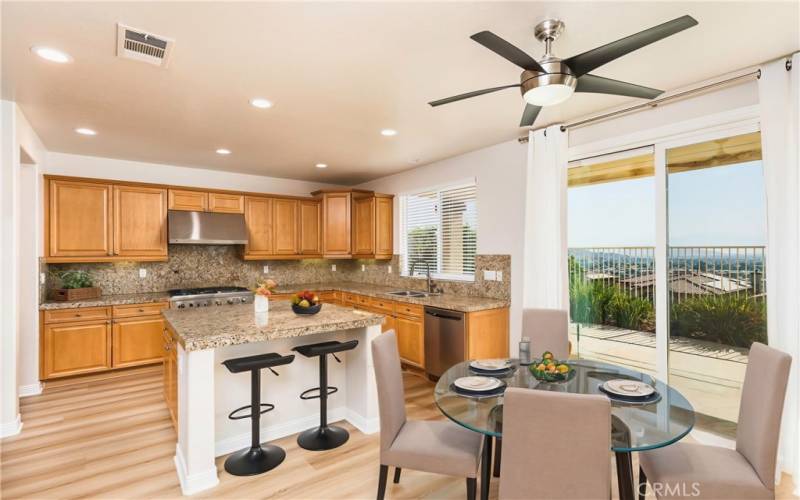 Kitchen with slider to backyard and view of Canyon Lake - this image has been virtually staged