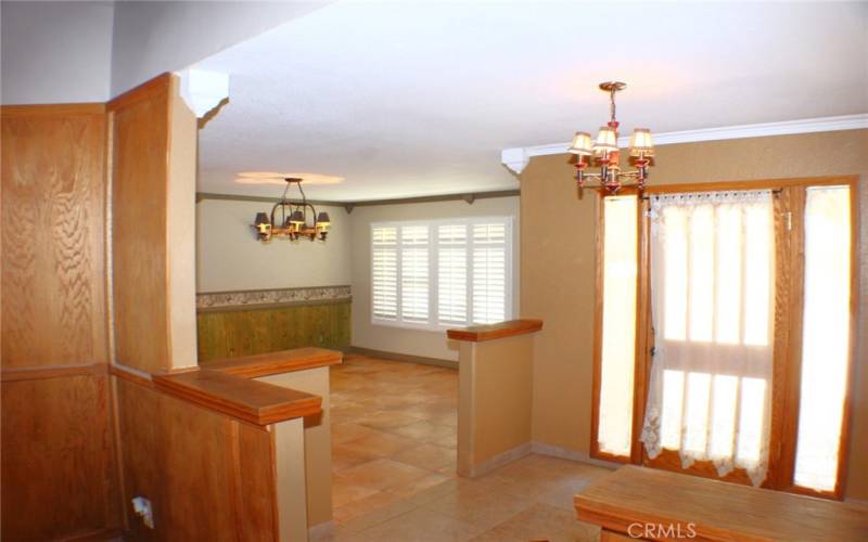 Formal Dining Room with Plantation Shutters and Tile Floors.