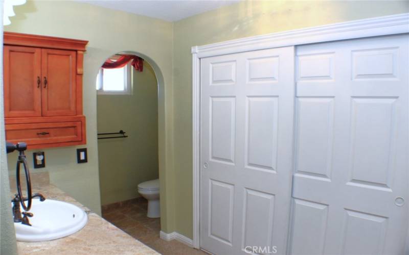 Remodeled Primary Bathroom with closets, granite counters and more.