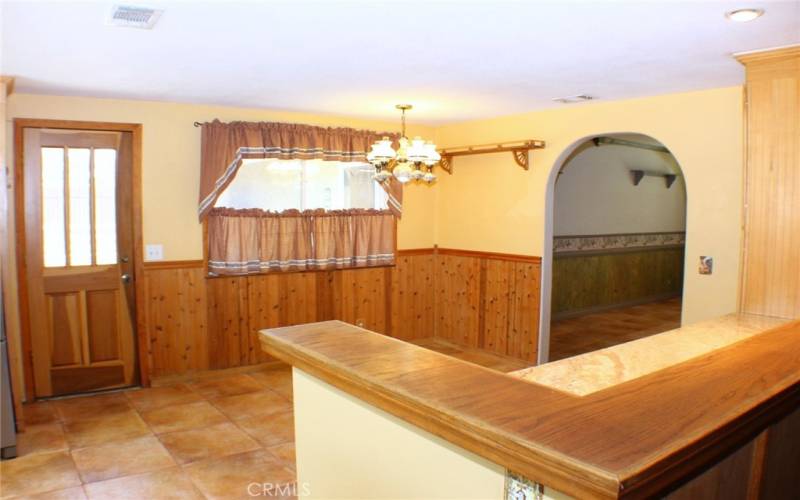 Kitchen Nook with Door to the back side of garage.