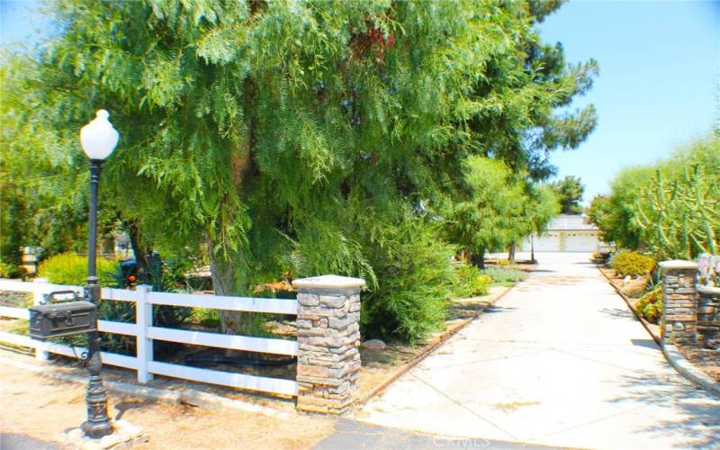 Stacked Stone and Vinyl Split Rail Fences at the front of the property.