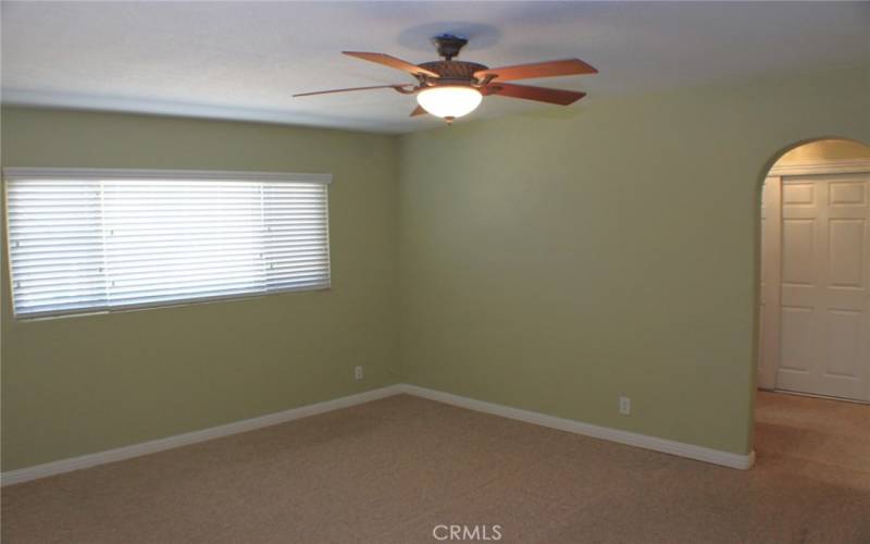 Large Primary Bedroom with blinds and Ceiling Fan